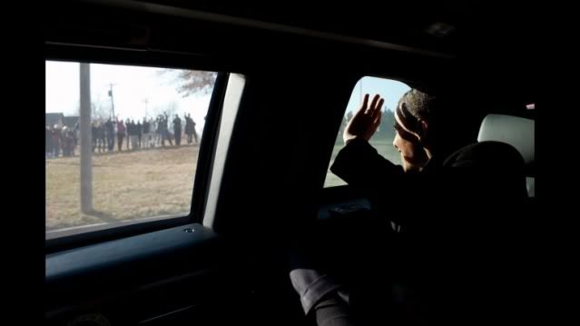 President Barack Obama waves to people gathered along the motorcade route from Osawatomie High School to Osawatomie-Paola Municipal Airport in Osawatomie, Kan., Dec. 6, 2011. (Official White House Photo by Pete Souza)