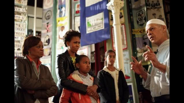 First Lady Michelle Obama, along with Marian Robinson and daughters Sasha and Malia, listens to former resident Noor Ebrahim as they visit the District Six Museum in Cape Town, South Africa, June 23, 2011. Ebrahim described the forced segregation that occurred after 1966 when District 6 was declared a 